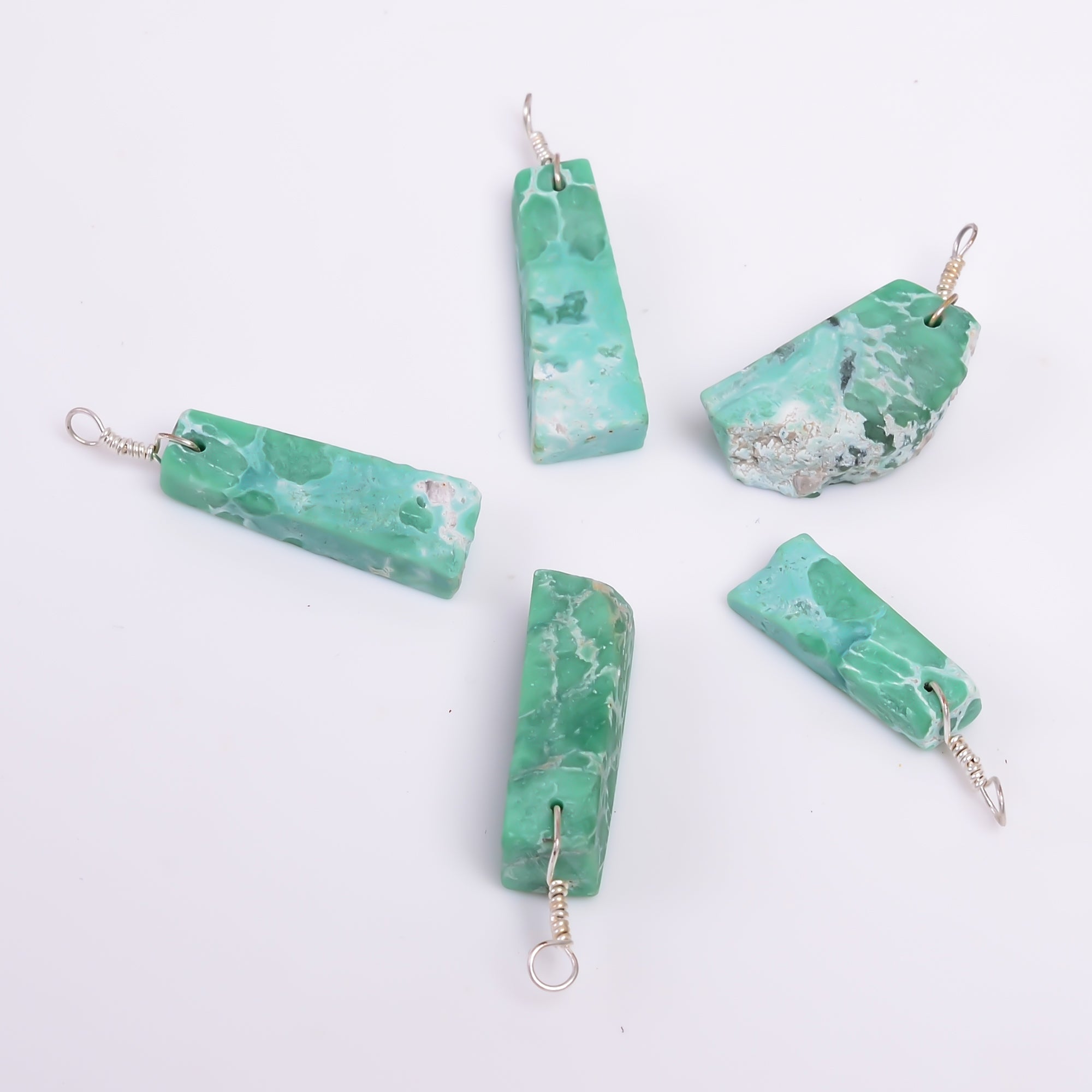Natural variscite raw stone pendant photographed on a white background with green gemstone patterns and silver-plated finish