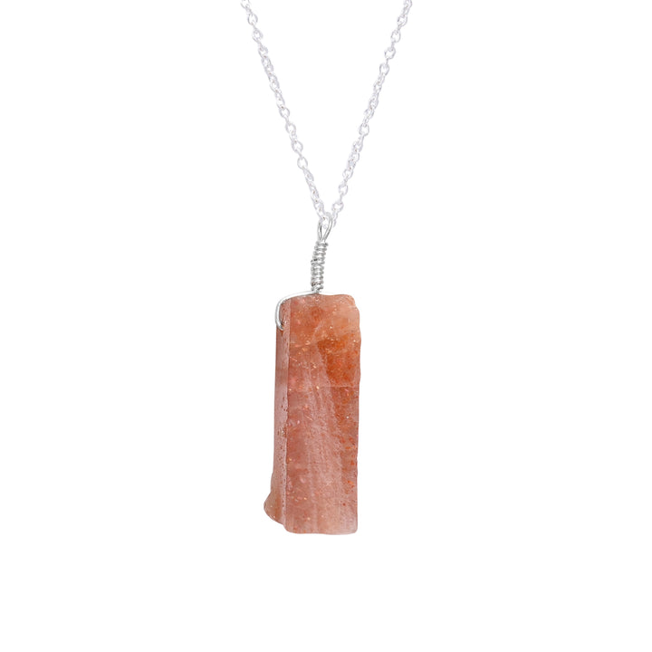 Raw sunstone bar pendant necklace shown worn on neck highlighting warm orange hues and healing energy vibes