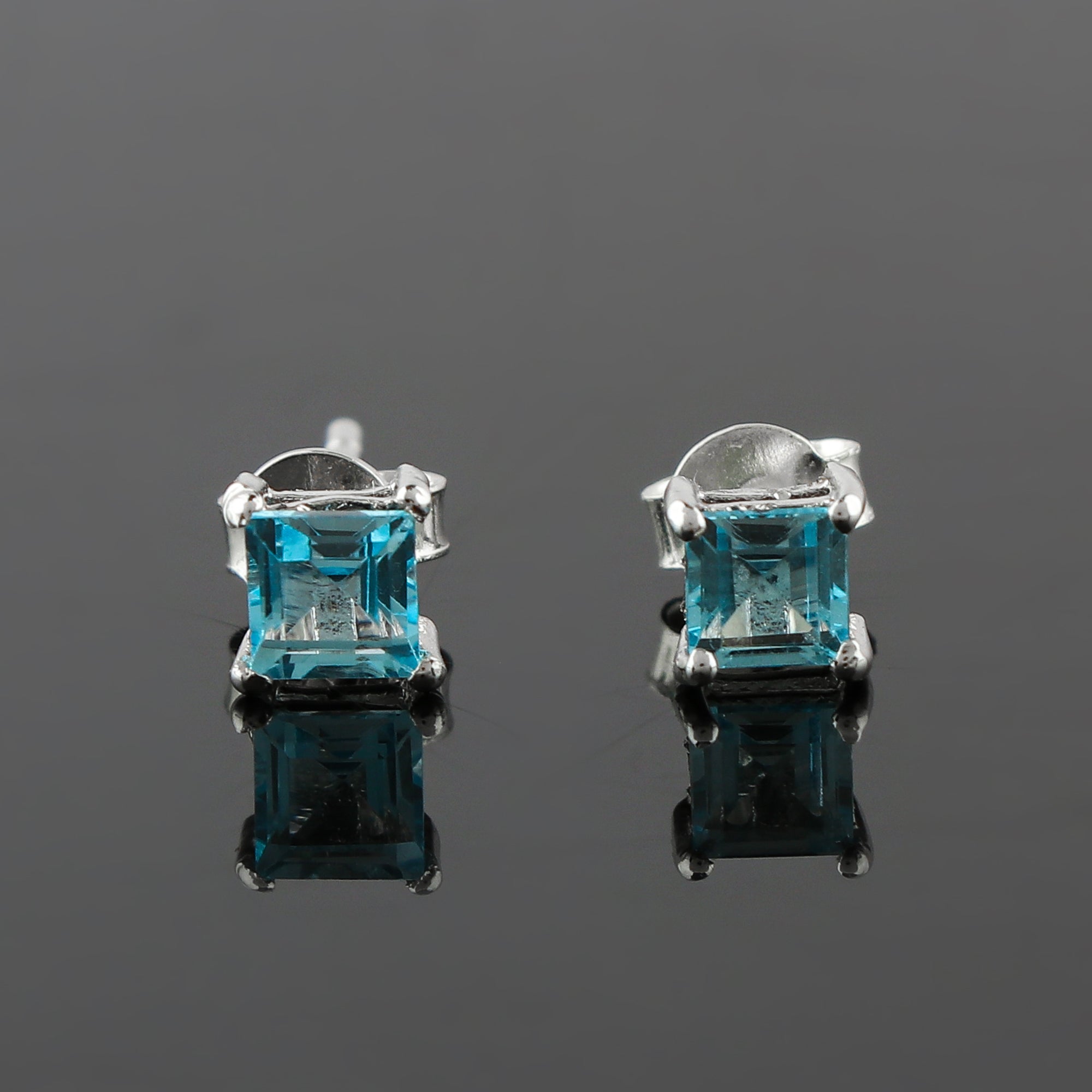925 Sterling Silver Crafted Stud Earrings, each made with a 4x4 mm Sky Blue Topaz
