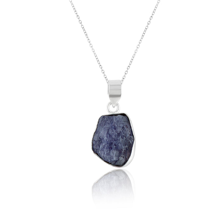 Natural tanzanite raw gemstone pendant in bezel setting displayed on an 18-inch silver-plated chain against a white background