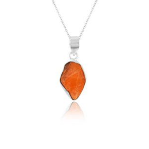 Orange triplite raw gemstone pendant in bezel setting shown on silver-plated chain against a clean white studio background