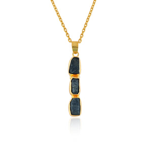Natural sapphire raw crystal pendant necklaces displayed in a row with irregular blue gemstones set in gold-plated bezels on 18-inch chains