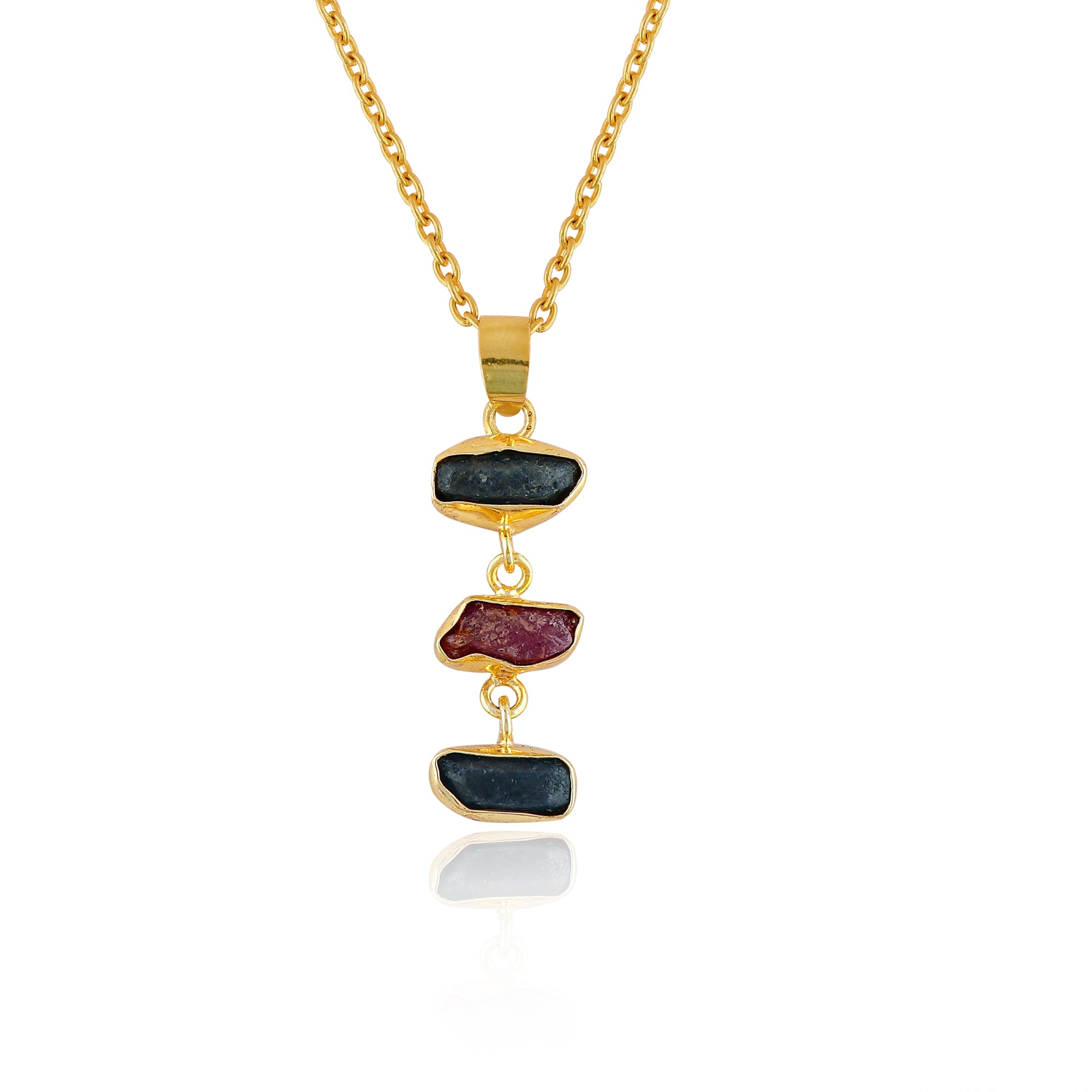 Raw sapphire and ruby crystal pendant necklace in gold-plated bezel displayed on white background showing vibrant blue and pink stones
