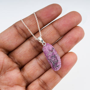 Close-up of Raw Ruby Crystal Pendant Necklace on Silver-Plated Brass Chain