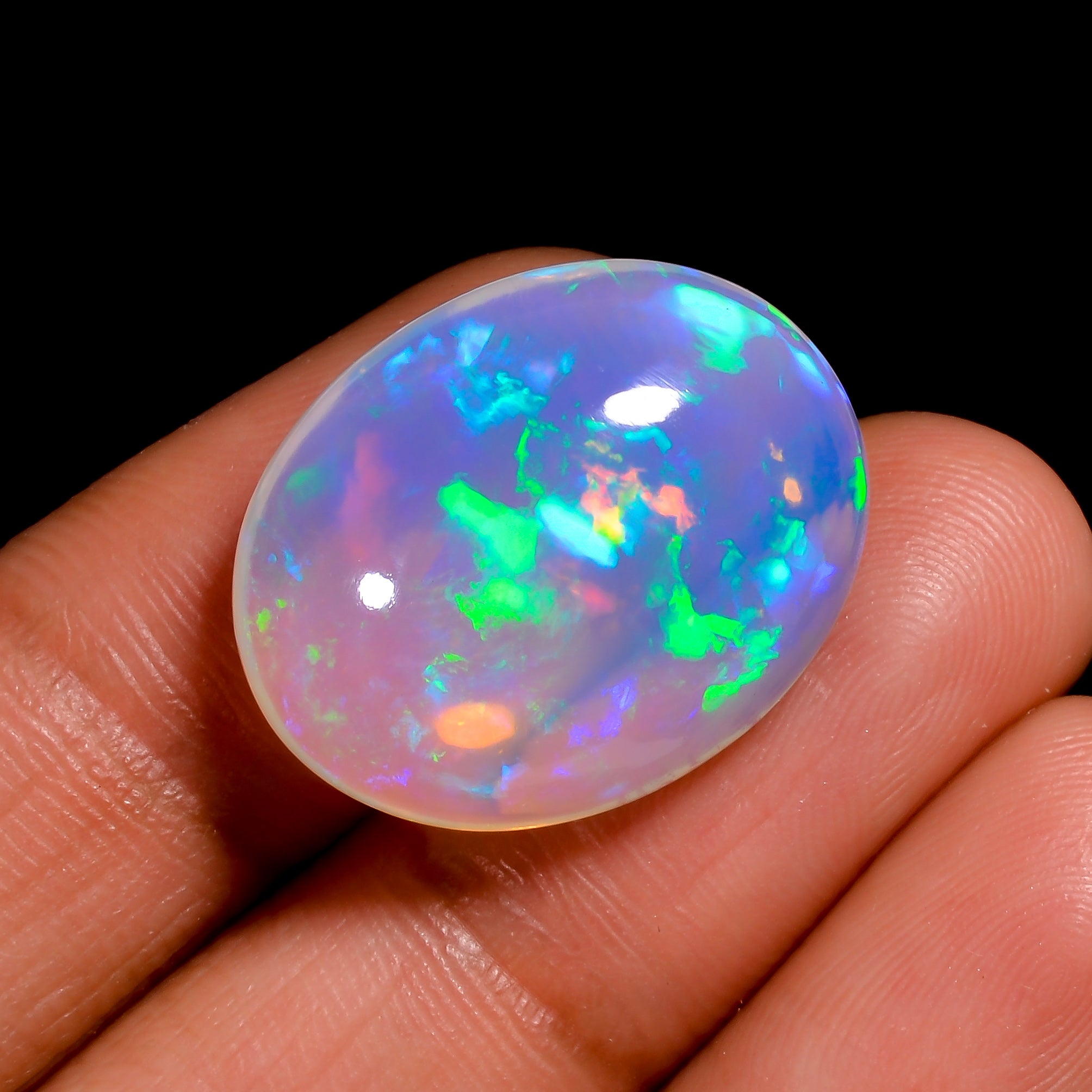 Genuine 14.00 Ct white Ethiopian opal gemstone showcasing radiant play of colors.
