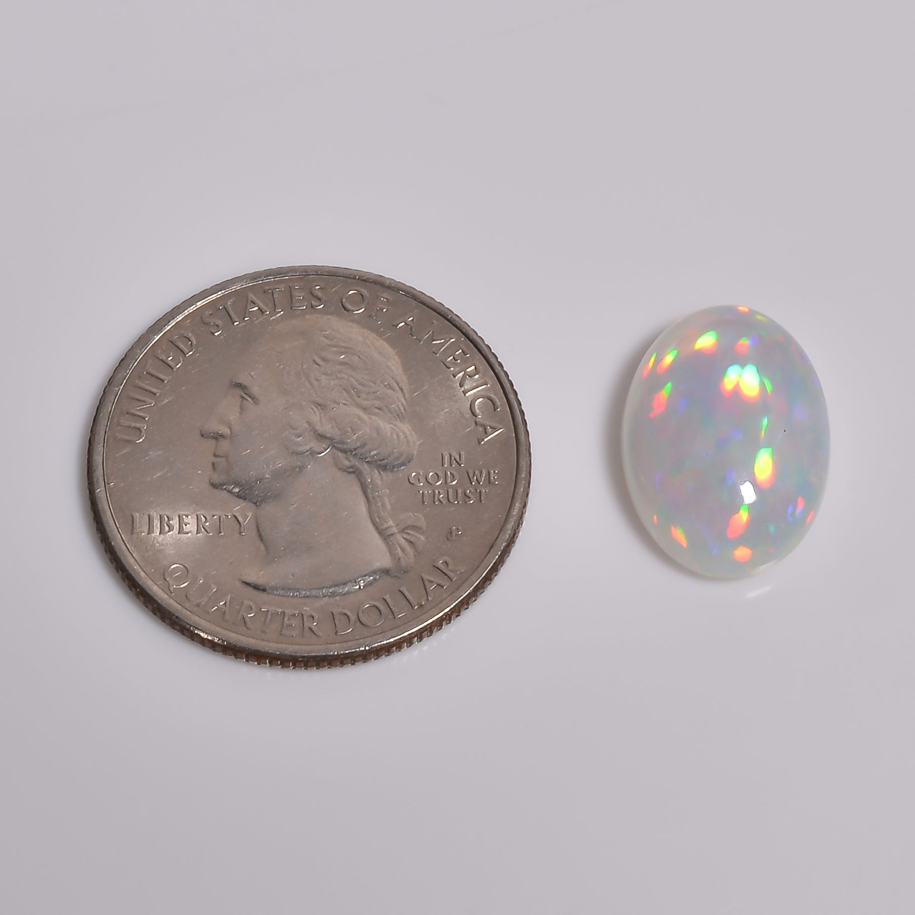 6.00 carat white Ethiopian opal loose gemstone with vibrant color play, available at Armoniagems.

